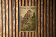 A postage stamp featuring a bird perched on a pine tree, with the text "PINE SISKIN" prominently displayed.