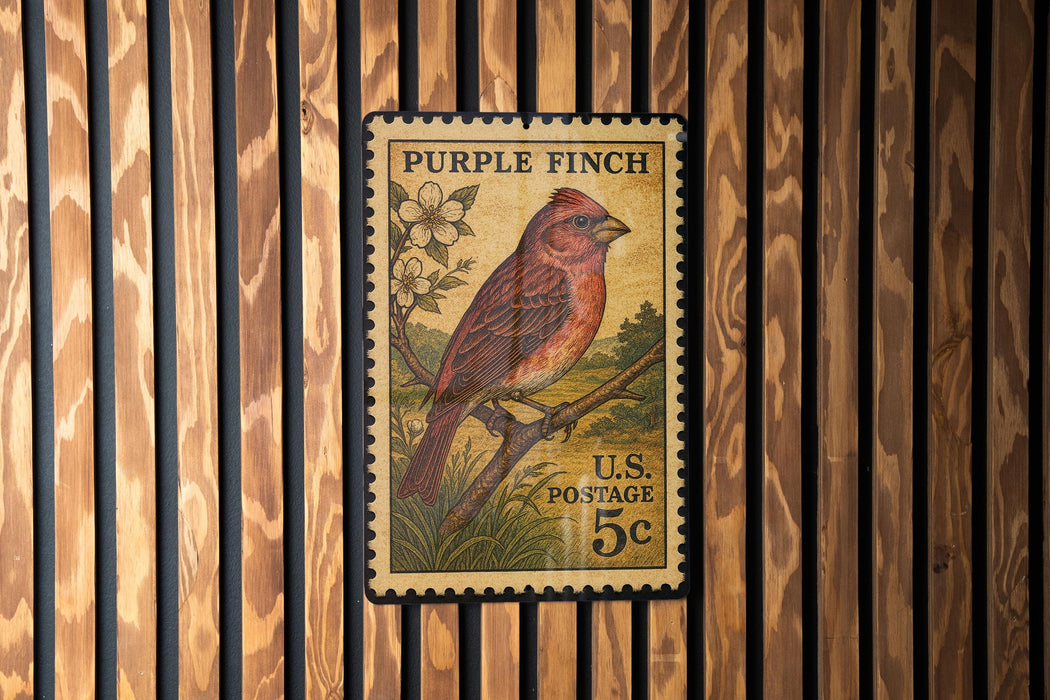 A vintage Purple Finch postage stamp is displayed on a wooden wall.