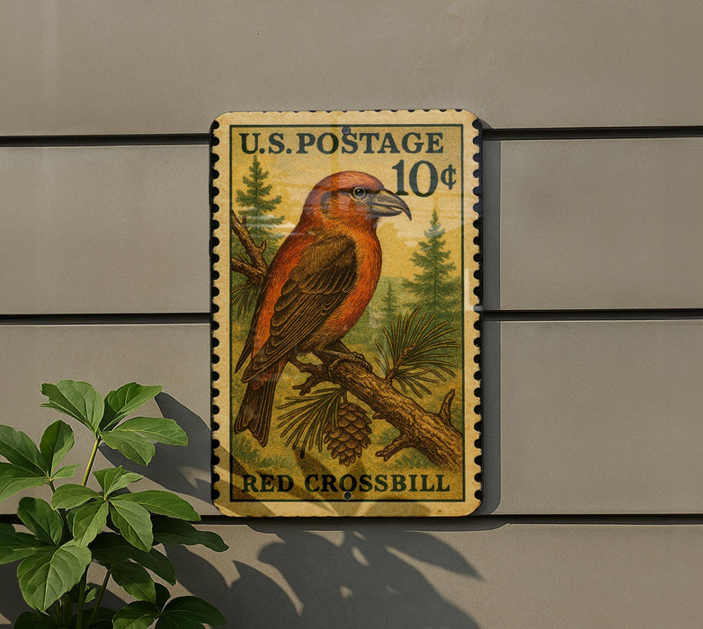 A U.S. postage stamp featuring a red bird perched on a branch, with the text "U.S. POSTAGE 10¢" and "RED CROSSBILL" printed on it.