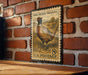 A vintage U.S. postage stamp featuring a pheasant standing in a grassy field.