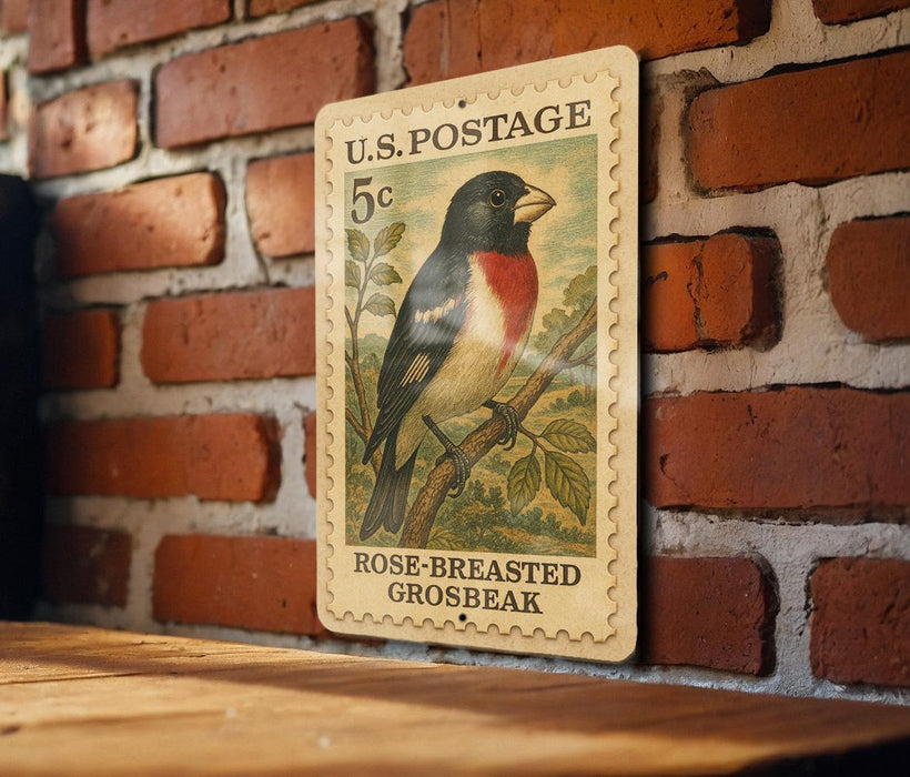 A U.S. postage stamp featuring a colorful illustration of a bird, specifically a rose-breasted grosbeak, perched on a branch.