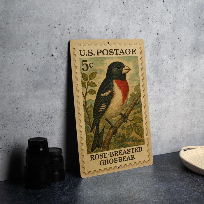 A U.S. postage stamp featuring a colorful illustration of a bird, specifically a rose-breasted grosbeak, perched on a branch.