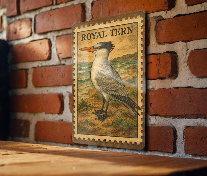 A vintage-style postage stamp featuring a detailed illustration of a bird, likely a tern, is displayed on a brick wall.
