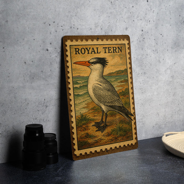 A wooden postcard featuring a bird, specifically a seagull, with the text "ROYAL TERN" printed on it.