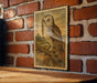 a framed illustration of an owl perched on a branch, mounted on a brick wall.