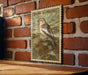 A vintage-style stamp depicting a bird, likely a sparrow, is mounted on a brick wall.