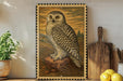 A framed illustration of a white owl is displayed on a shelf, with a wooden cutting board and a potted plant nearby.