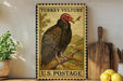 A vintage-style postage stamp featuring a turkey vulture, with the text "TURKEY VULTURE" and "U.S. POSTAGE" printed on it. The stamp is displayed on a shelf next to a wooden cutting board and a potted plant.