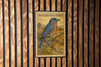 A U.S. postage stamp featuring a bluebird perched on a branch, with the text "WESTERN BLUEBIRD" and "15c" printed on it.