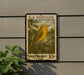 A U.S. postage stamp featuring a yellow warbler, with the text "U.S. POSTAGE" and "YELLOW WARBLER 10c" printed on it.
