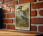 A framed illustration of a yellow-crowned night heron is displayed on a brick wall.