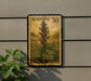 a postage stamp with a detailed illustration of a plant, specifically a flower, mounted on a wall.
