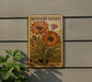 a wooden sign with a floral design, mounted on a wall next to a plant.