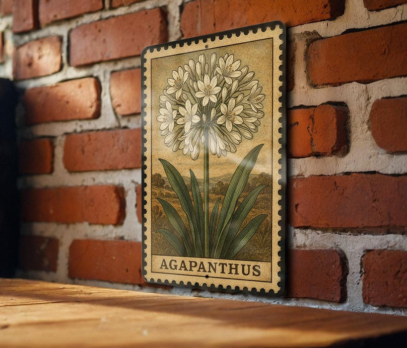 A vintage-style metal stamp depicting a flower with the word "AGAPANTHUS" printed on it, mounted on a brick wall.