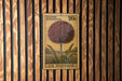 A U.S. postage stamp featuring an illustration of a flower on a wooden background.
