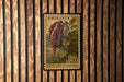 a postage stamp from Amaranth, depicting a plant with red berries and green leaves, hanging on a wooden wall.