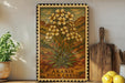 a framed illustration of a desert plant with yellow flowers, placed on a shelf next to a wooden cutting board and a potted plant.