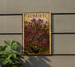 a wooden sign with a floral design, mounted on a wall next to a plant.