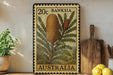 a 20c Australian postage stamp with a detailed illustration of a flowering plant, placed on a wooden surface next to a wooden cutting board and a potted plant.