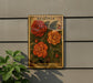 A vintage-style metal sign with a floral illustration of red and orange flowers, mounted on a wall next to a plant.