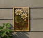 A postage stamp featuring two white flowers with green leaves, mounted on a wall next to a plant.