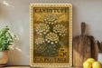 A vintage-style postage stamp featuring a floral design, placed on a shelf next to a wooden cutting board and some potted plants.