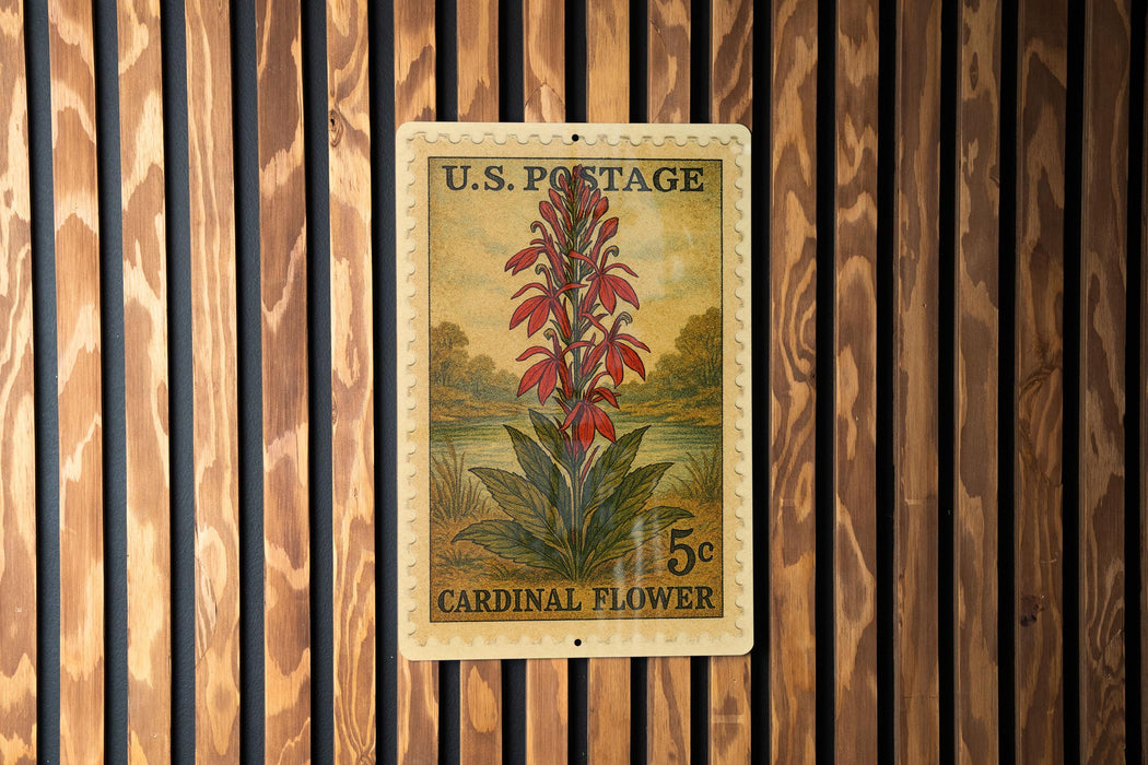 A U.S. postage stamp featuring a vibrant red cardinal flower, mounted on a wooden wall.