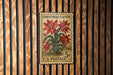 A vintage U.S. postage stamp featuring a Christmas cactus plant on a wooden background.