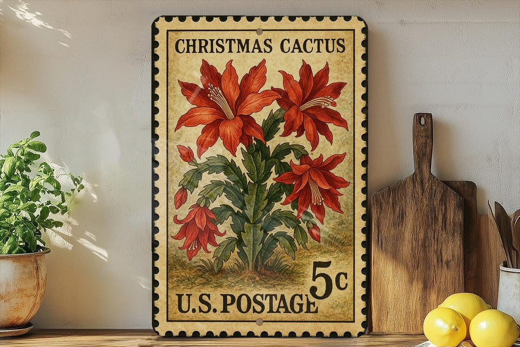 A vintage Christmas cactus postage stamp from the U.S. Postal Service, featuring a large red flower surrounded by green leaves, displayed on a shelf next to a wooden cutting board and a potted plant.