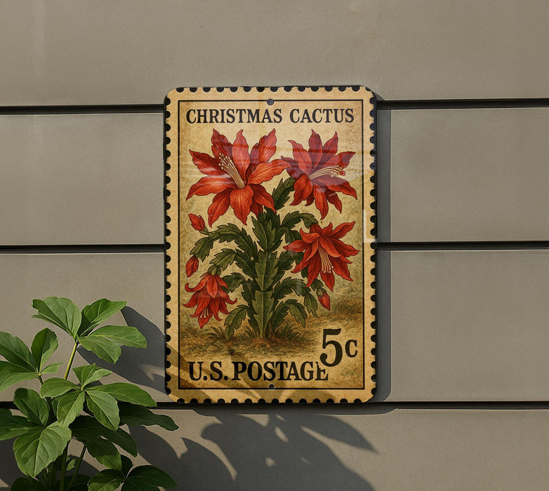 A vintage Christmas cactus postage stamp is displayed on a wall, with a potted plant to the left.