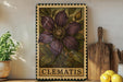 A framed illustration of a clematis flower is displayed on a shelf, accompanied by a wooden cutting board, a potted plant, and some lemons.