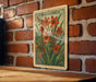 A framed illustration of crocus flowers is hanging on a brick wall.