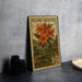 A metal stamp featuring a vibrant illustration of a flame azalea plant, with the text "FLAME AZALEA" and "USA 20c" printed on it.
