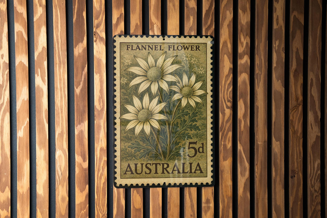 A vintage Australian postage stamp featuring a floral design is displayed on a wooden wall.