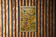 a vintage-style postage stamp with a floral design, mounted on a wooden wall.