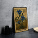 A postage stamp featuring a blue iris flower, with the text "USA 20c" and "Gentian (Fringed)" printed on it. The stamp is placed on a table next to some black camera lenses.