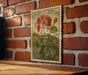 A vintage-style metal stamp depicting a geranium plant is displayed on a brick wall.