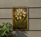 a framed painting of a white flower on a wall, with a plant next to it.