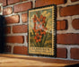 A framed illustration of a flower, specifically a Gladiolus (minature) flower, is displayed on a brick wall.