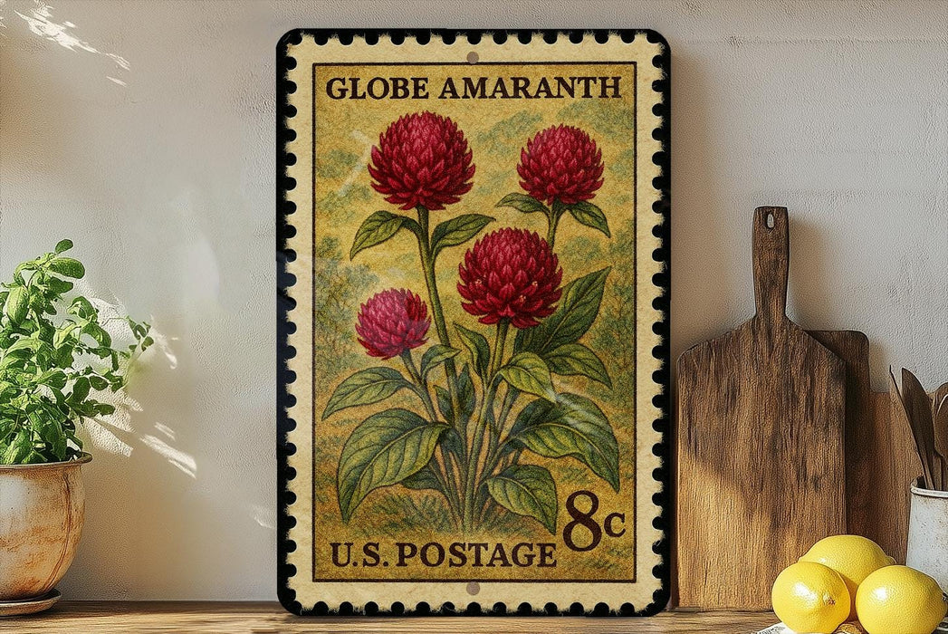 A vintage-style postage stamp featuring a vibrant illustration of red flowers, placed on a wooden surface next to a wooden cutting board and a potted plant.