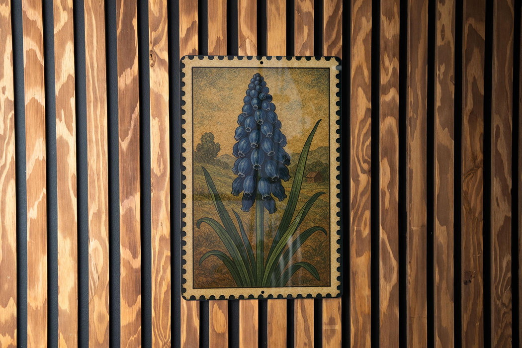 a framed painting of a blue flower on a wooden wall.