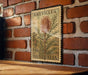a vintage postage stamp with a floral design, mounted on a brick wall.