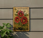 A vintage-style postage stamp featuring a red hollyhock plant, mounted on a wall next to a plant.