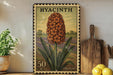 A postage stamp featuring a large orange flower, likely a hyacinth, is displayed on a shelf next to a wooden cutting board and some kitchen utensils.