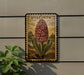 a decorative plant with a large flower, possibly a hyacinth, displayed on a wall.