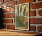 A framed illustration of blue flowers is hanging on a brick wall, with the word "HYSSOP" visible below the illustration.
