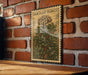 A vintage-style stamp depicting a jade plant flower is displayed on a brick wall.
