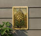 A postage stamp featuring a Joshua tree flower is displayed on a wall, with a plant to the left.