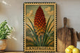 A framed illustration of a kniphofia plant is displayed on a shelf, accompanied by a wooden cutting board, a potted plant, and some lemons.