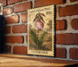 A vintage-style postage stamp featuring a pink flower, mounted on a brick wall.